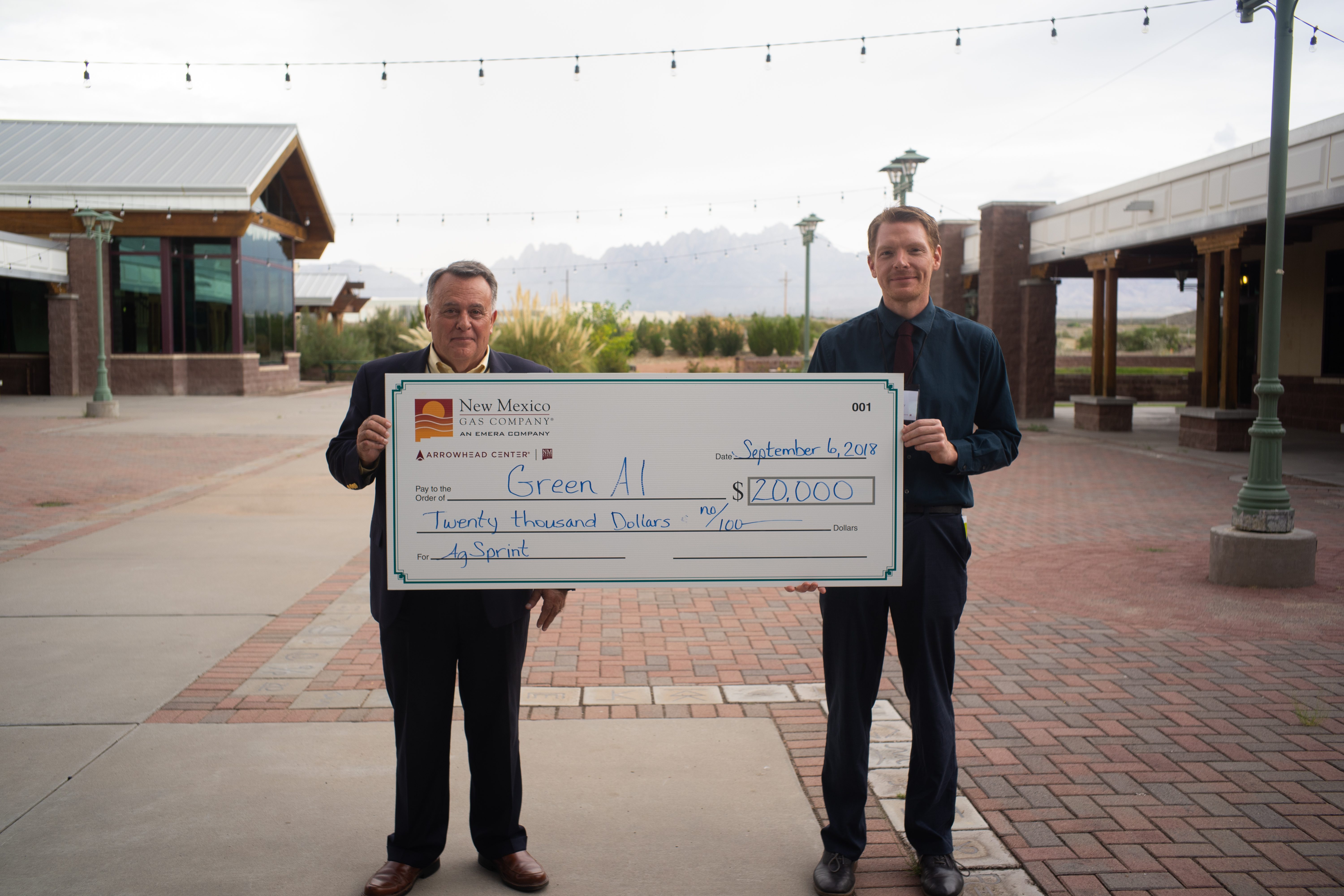 Cliff Hudson (left), chief technology officer of Systems Technology Solutions, recently secured a $20,000 investment for GreenAI, an innovative sensor technology for <br> crop analytics, through the AgSprint business accelerator program at New Mexico State University ’s Arrowhead Center. The check was presented to Hudson at the <br>second annual AgAssembly conference in Las Cruces. At right is Del Mackey, program specialist at Arrowhead Center. (NMSU courtesy photo)